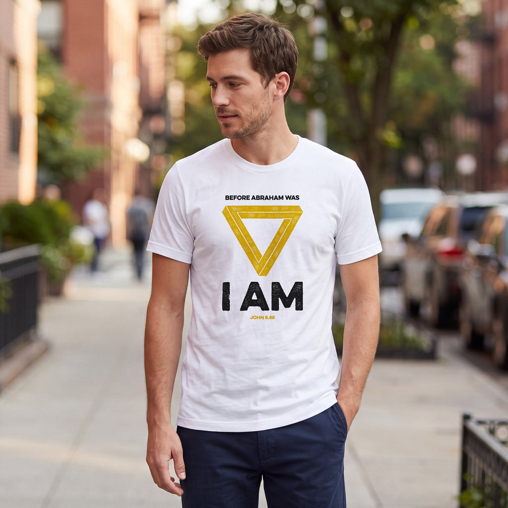 Man standing on an urban street wearing a white t-shirt with John 8.58 graphic printed on the front.