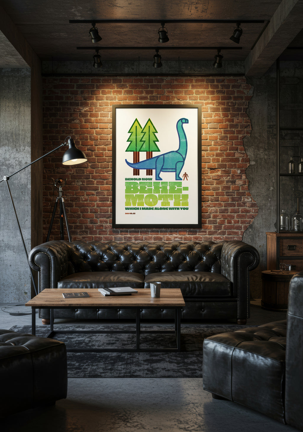 Job 40:15 print in a black frame, styled over a black leather Chesterfield sofa in an industrial living room.