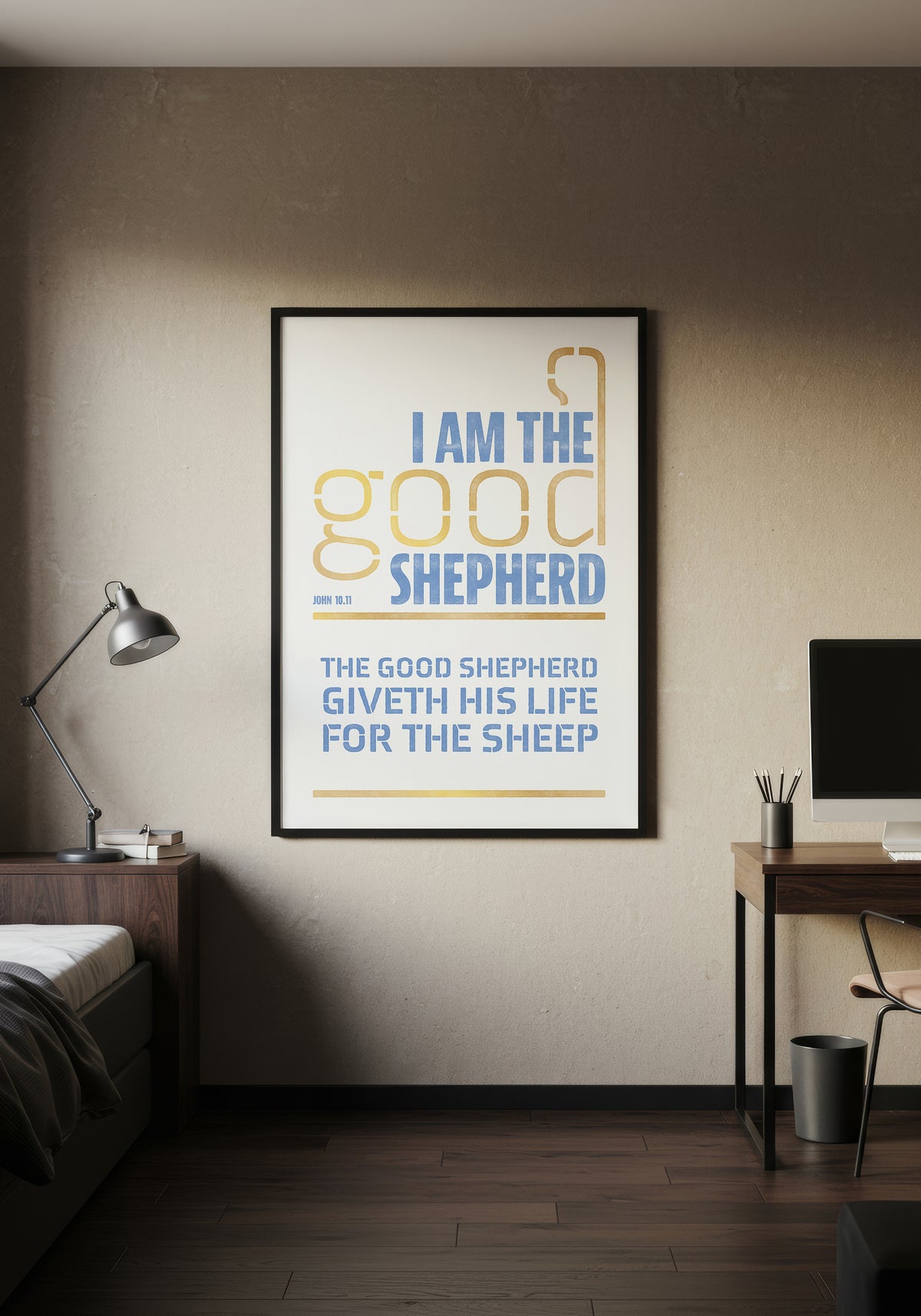 John 10:11 art print in a black frame, displayed on a wall in a minimalist, warmly lit bedroom.