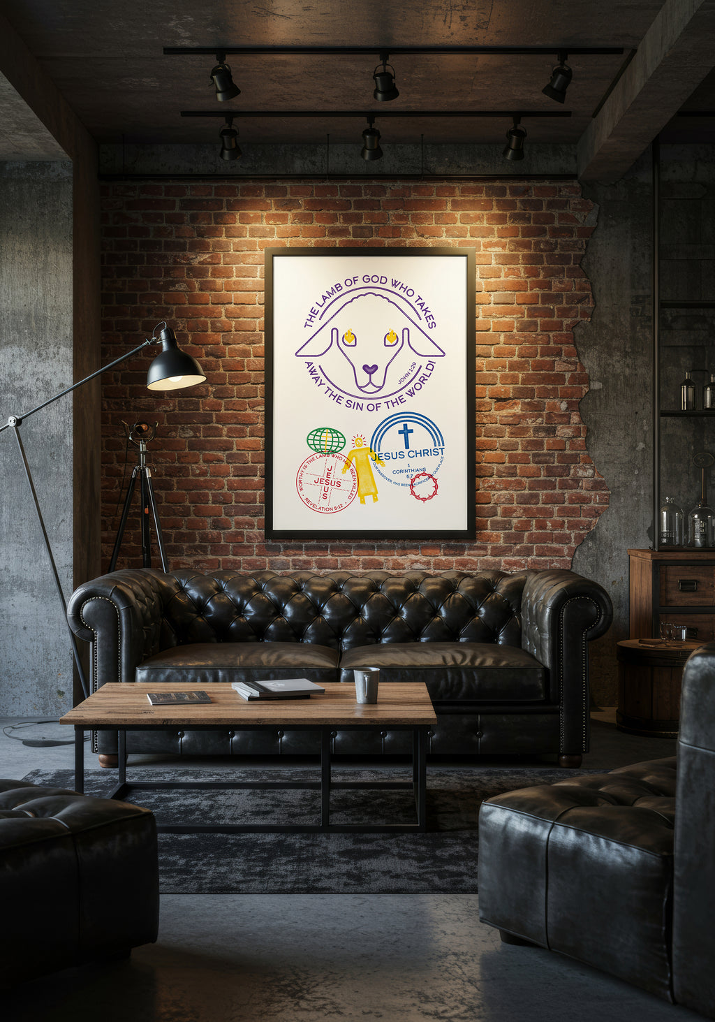 John 1:29 art print in a black frame, displayed above a black leather sofa in an industrial-style living room.