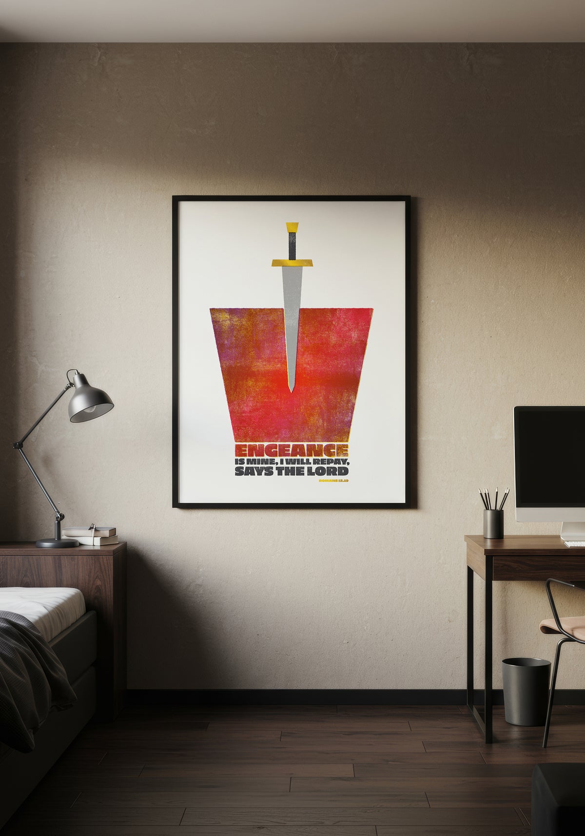 Romans 12:19 scripture art print in a black frame, displayed on a wall in a minimalist, warmly lit bedroom.