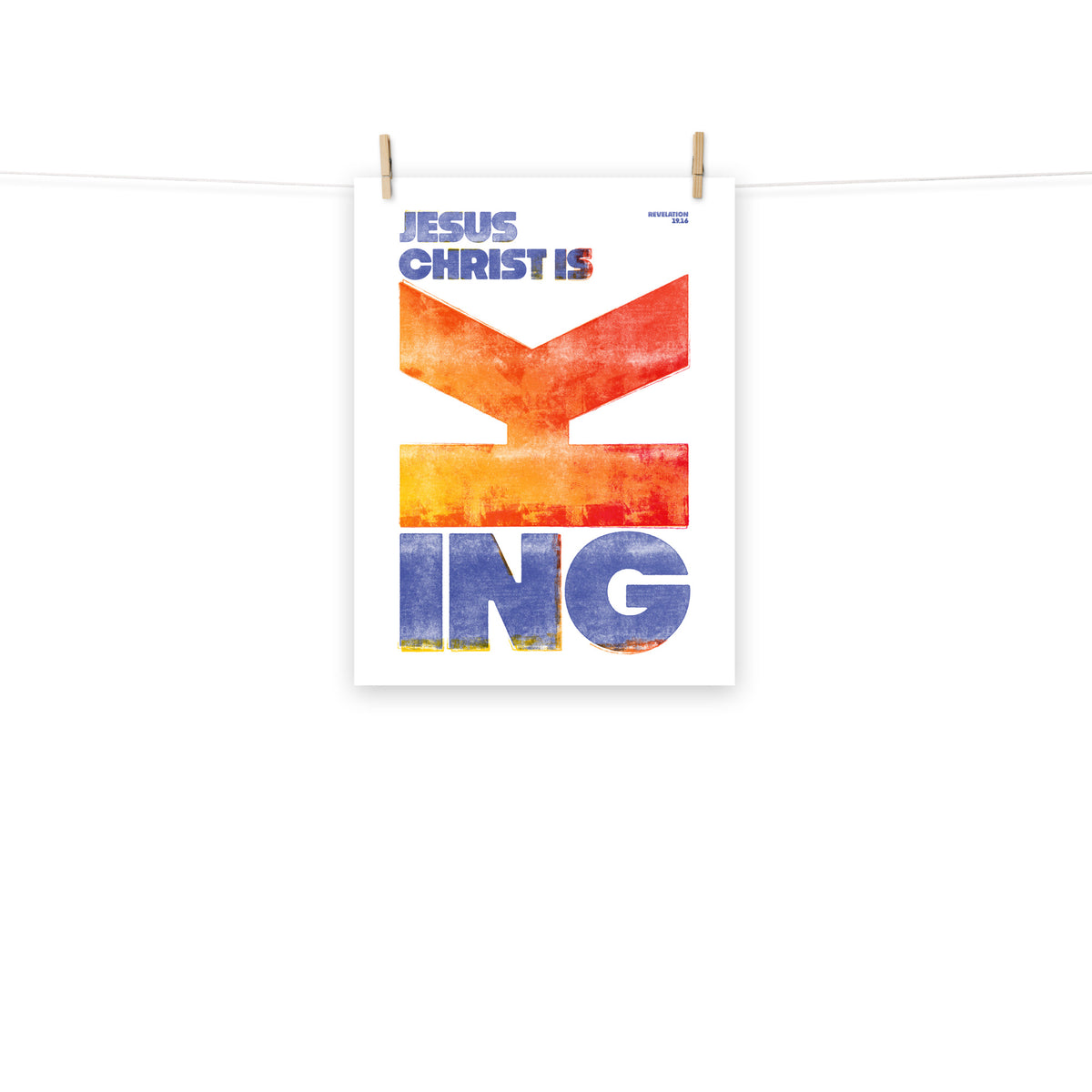 Full view of the Revelation 19:16 poster scroll, hung by wooden clips and rope, showing the complete design.