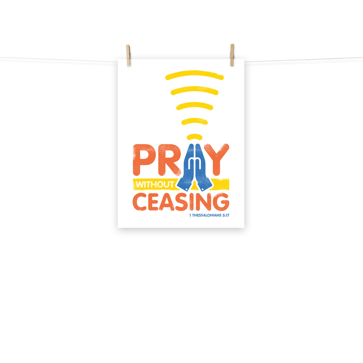 Full view of the 1 Thessalonians 5:17 poster scroll, hung by wooden clips and rope, showing the complete design.