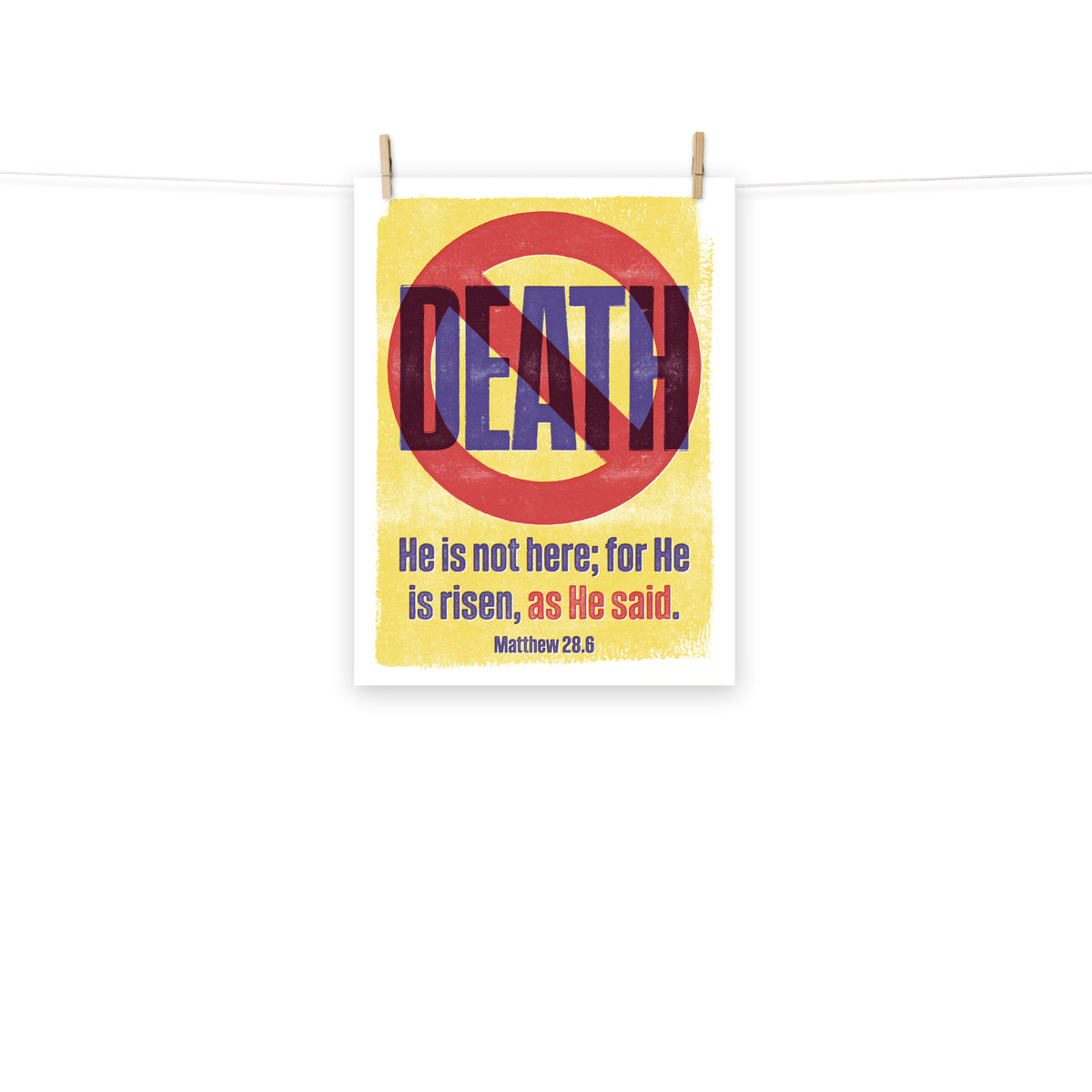 Full view of the Matthew 28:6 poster scroll, hung by wooden clips and rope, showing the complete design.
