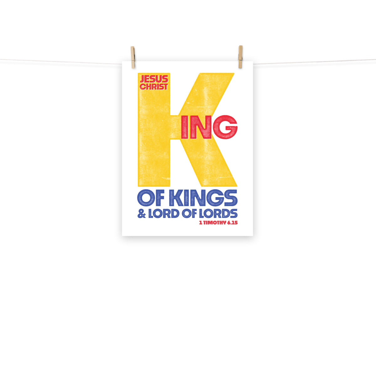 Full view of the 1 Timothy 6:15 poster scroll, hung by wooden clips and rope, showing the complete design.