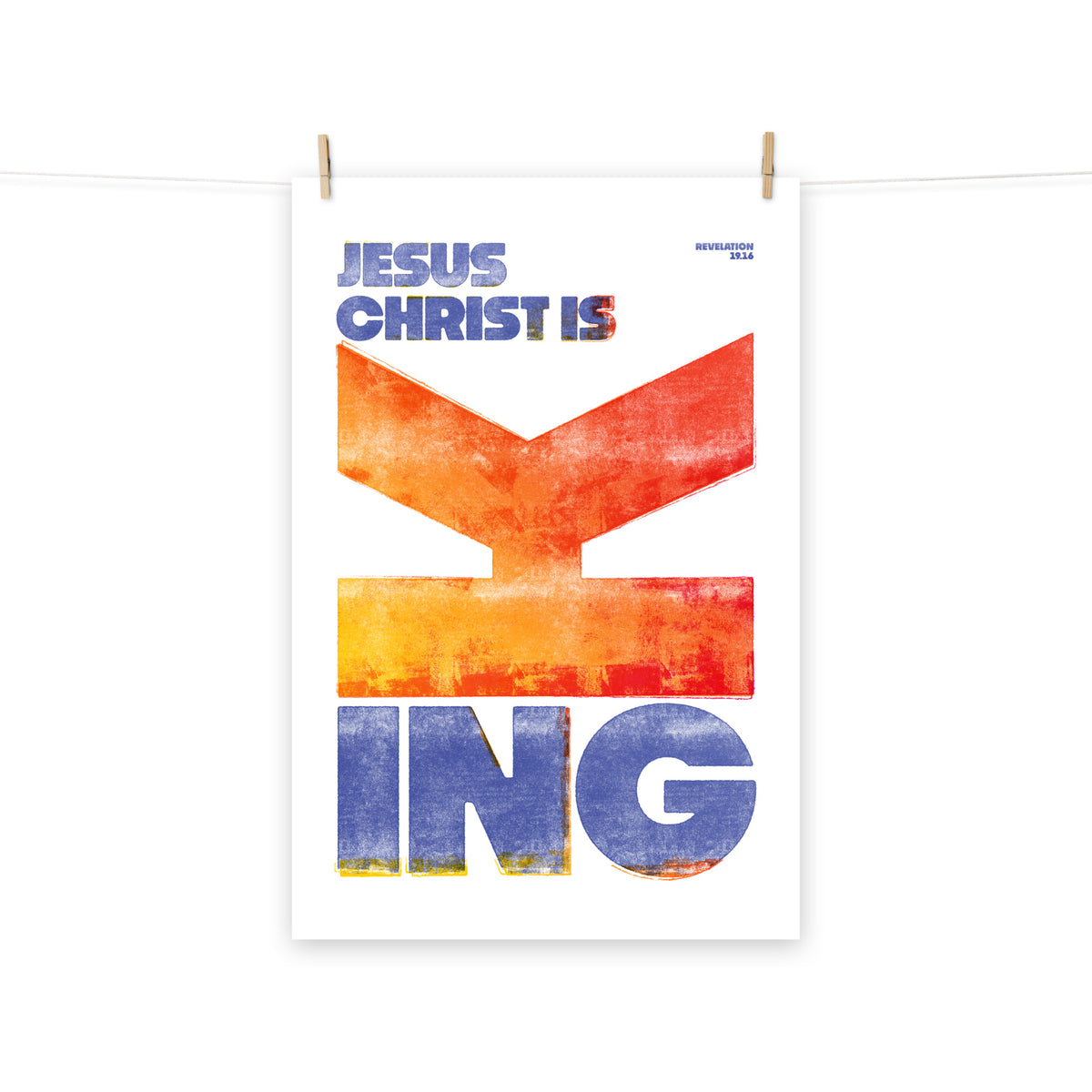 Full view of the Revelation 19:16 poster scroll, hung by wooden clips and rope, showing the complete design.