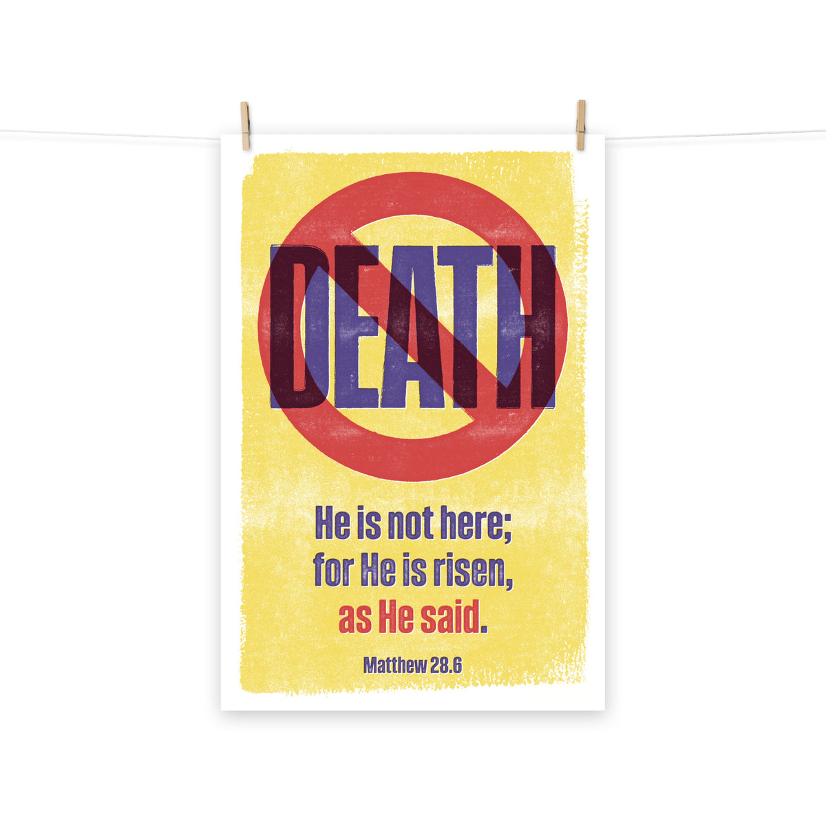 Full view of the Matthew 28:6 poster scroll, hung by wooden clips and rope, showing the complete design.