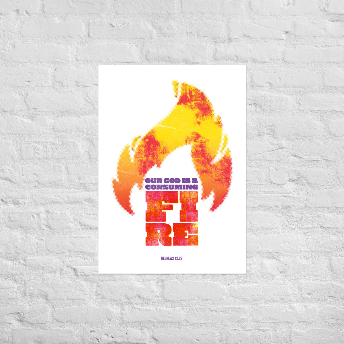 Hebrews 12:29 print mounted directly on a white brick wall for a frameless, modern look.