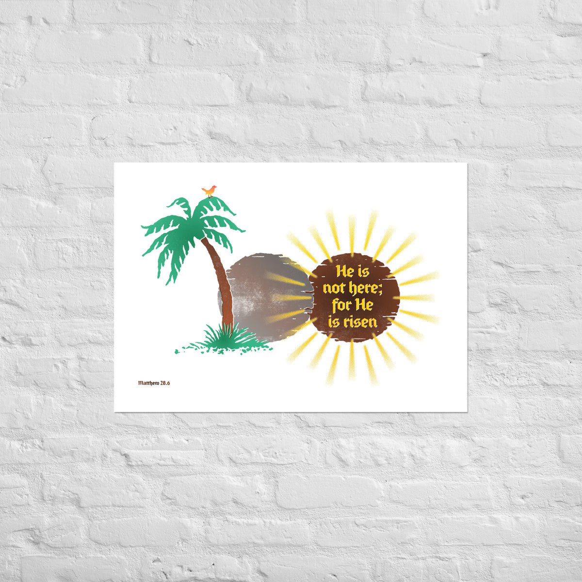 Matthew 28:6 print mounted directly on a white brick wall for a frameless, modern look.