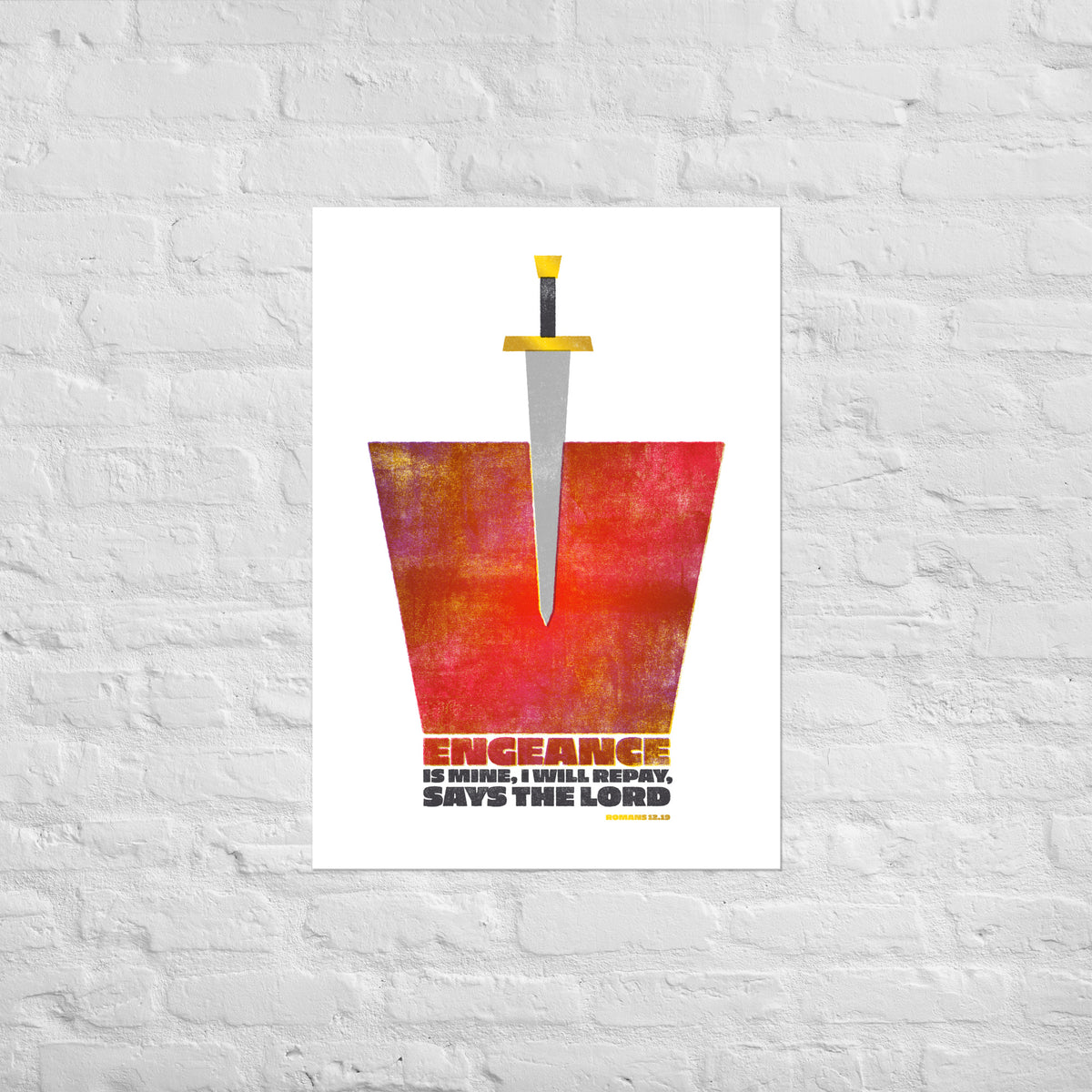 Romans 12:19 scripture print mounted directly on a white brick wall for a frameless, modern look.