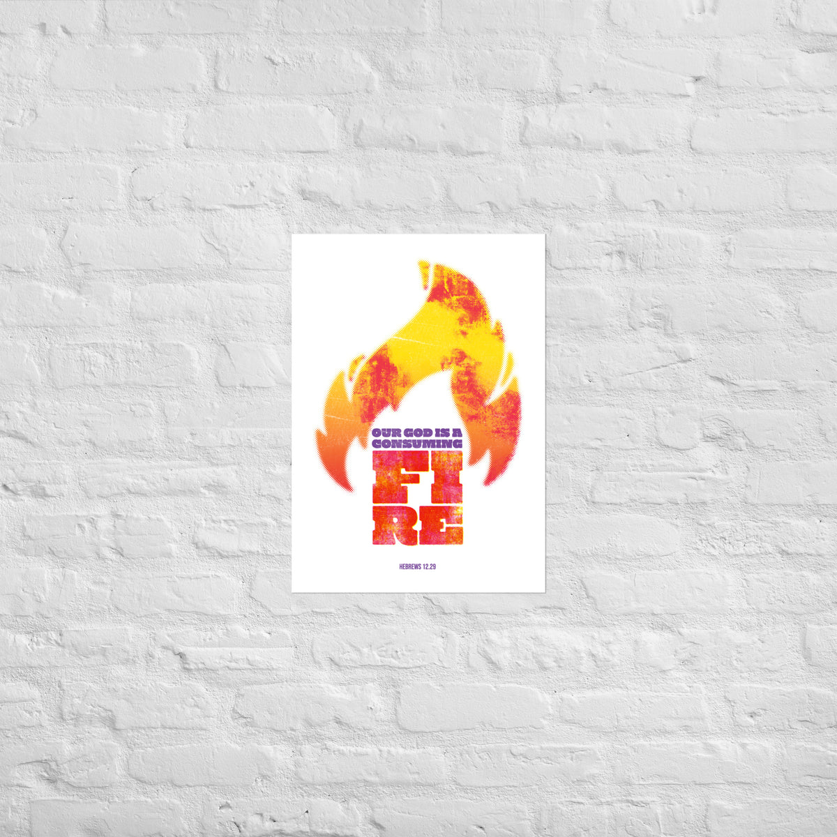 Hebrews 12:29 print mounted directly on a white brick wall for a frameless, modern look.