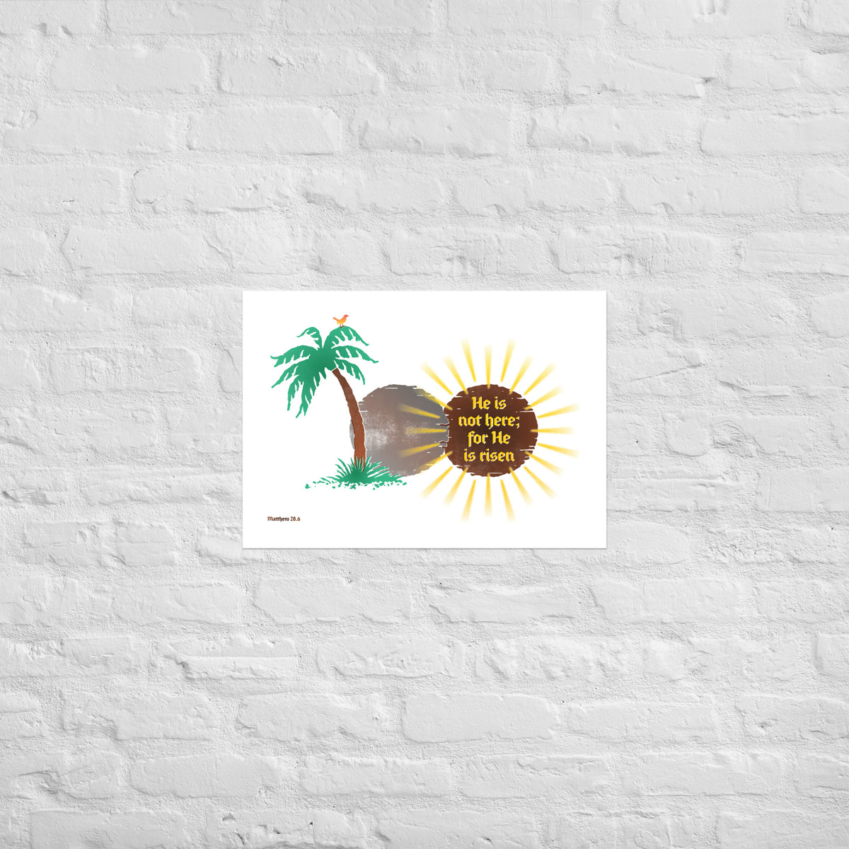 Matthew 28:6 print mounted directly on a white brick wall for a frameless, modern look.
