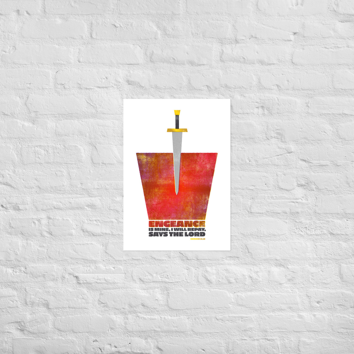 Romans 12:19 scripture print mounted directly on a white brick wall for a frameless, modern look.